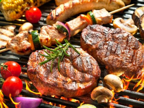 assorted,delicious,grilled,meat,with,vegetables,over,the,coals,on
